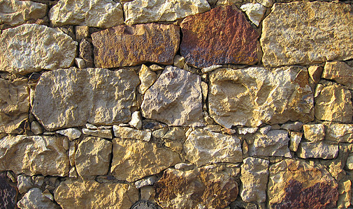 石头墙的颜色更丰富多彩 随机化石块水泥房子砂岩石工岩石历史性原石砂浆花岗岩石墙图片