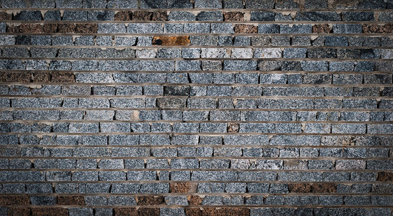 花岗岩墙墙干旱建筑石头地面宏观材料岩石框架矿物棕色图片