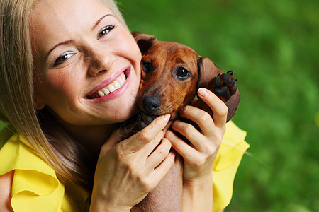 在她的怀里 有达赫松德的女子犬类哺乳动物动物小狗拥抱眼睛爪子女性成人香肠图片