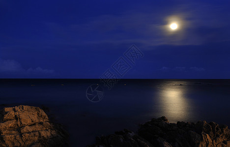 月亮在海面上黑暗月光反射天空海洋岩石海景海岸照明图片