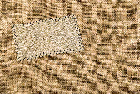 在麻布材料上贴背布标签线程织物麻袋棉布羊皮纸纤维粗糙度边界亚麻缠绕图片