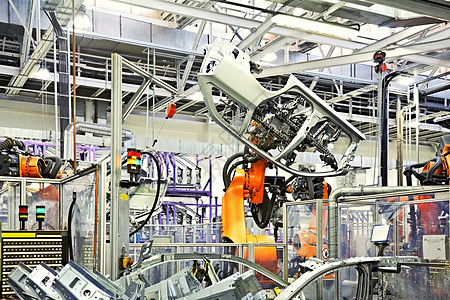 机械手臂汽车厂的机器人运输生产高科技工厂工程焊机技术植物安全平台背景