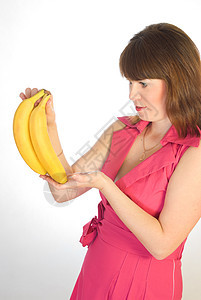 手拿着香蕉的美丽女孩食物成人水果微笑饮食果汁快乐眼睛头发橙子图片