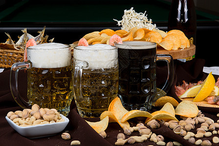 啤酒和零食美味盐渍午餐筹码液体金子开心果橙子玻璃小吃图片