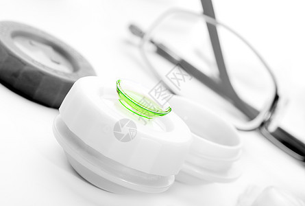 封闭有溶液的容器中的绿色隐形眼镜柔软度镜片眼镜卫生技术解决方案脆弱性近视强光白色图片