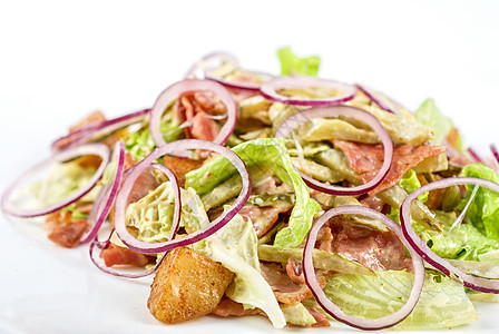 洋葱肉加烤蔬菜的洋葱沙拉油炸金子盘子树叶胡椒餐厅桌子洋葱木头旅行图片