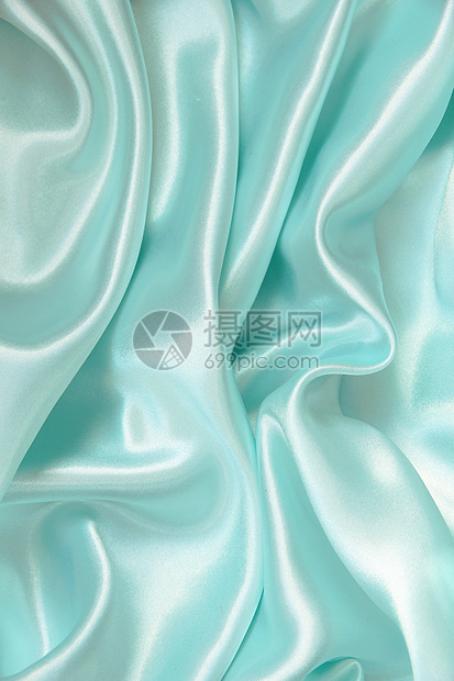 平滑优雅的蓝色丝绸作为背景材料织物纺织品投标折痕曲线布料银色海浪图片