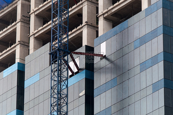 高楼建筑工地脚手架构造公寓办公室财产建筑学大厦蓝色城市窗户图片
