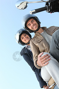在阳光下骑摩托车的情侣图片