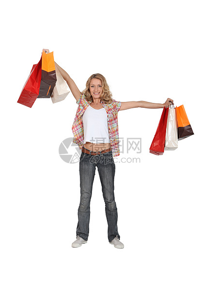 一名携带购物袋的妇女的肖像女士礼物视图店铺购物销售量休闲服牛仔裤乐趣金发女郎图片