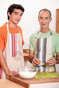 一个年轻人和一个做蛋糕的老头子背景图片