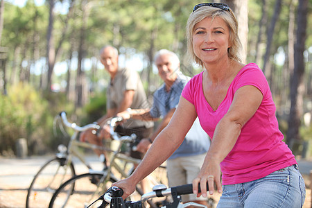 公园中骑自行车的老年人群体图片