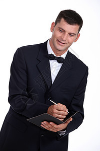 服务员下订单写作用餐服务精制服务器夹克男人顾客部门职员图片