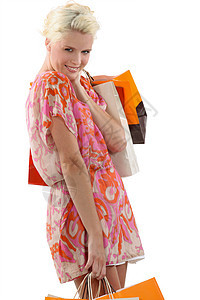 携带购物袋的妇女金发橙子肩膀粉色裙子女性女士白色工作室购物图片