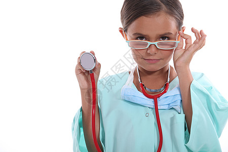 儿童穿戴成人的医院洗涤剂 眼镜和听诊器图片