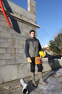 建立于站点的建设器房子安全帽男人建筑职员工作服工作头盔石工住房图片