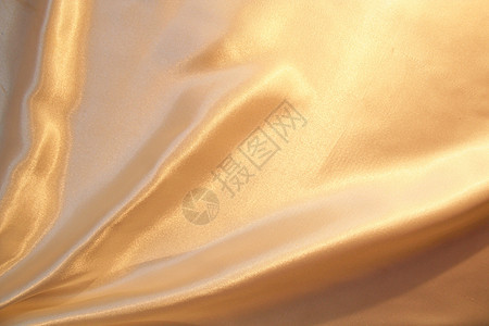 平滑优雅的金色作为背景投标感性金子黄色折痕纺织品材料奢华曲线丝绸图片