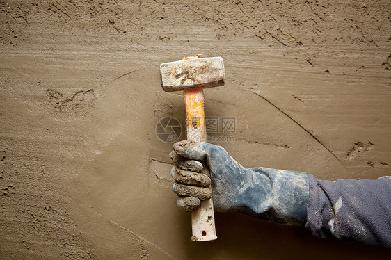 带手套的铁锤人 在石水泥背景下衰变工作砂浆男人手工劳动建筑拼装维修房子图片