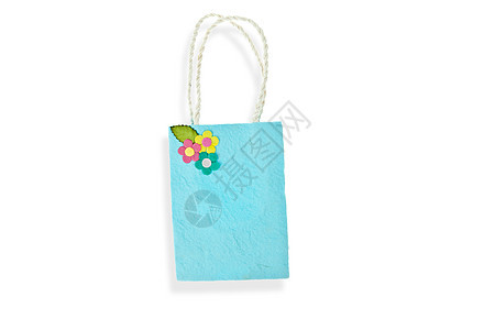 在白色背景上隔离的蓝毛莓纸袋黄色零售回收环境材料棕色购物粉色绿色叶子图片