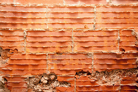 修复墙壁的砖墙中的破碎砖砖拼装房子橙子手工建筑衰变石头乡村接缝砂浆图片