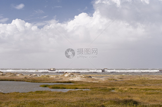 暴风暴洪水灯光冲浪暴风雨波浪沙丘建筑泥滩地平线海浪糕点图片