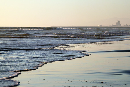 沙滩日落奥尔蒙海滩橙子蓝色旅行热带海浪天空海洋地平线反射冲浪图片