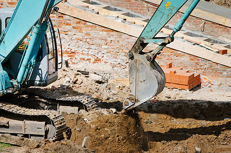 运行中的挖掘机建筑场毛虫推土机土壤工地建筑地机械建筑项目机器图片
