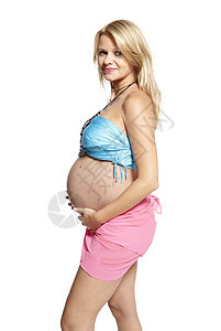 孕妇的肖像女士影棚母亲蓝色准妈妈幸福女人女性粉色肚子图片