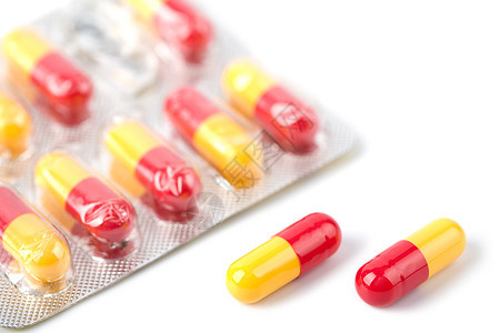 孤立的熔岩中的红色和黄色胶囊药丸疼痛制药治疗宏观白色疾病处方饮食预防药品图片