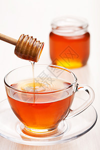 茶加蜂蜜芳香杯子饮料蜂蜜早餐橙子水滴瓶子餐厅糖浆图片