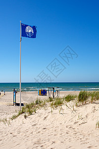 蓝旗海滩海洋联盟沙丘海岸线桅杆奖项认证天空旗帜蓝色背景图片