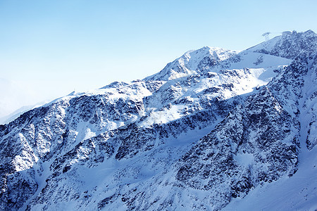 平面顶部暴风雪季节爬坡天空旅游高山运动旅行太阳岩石图片