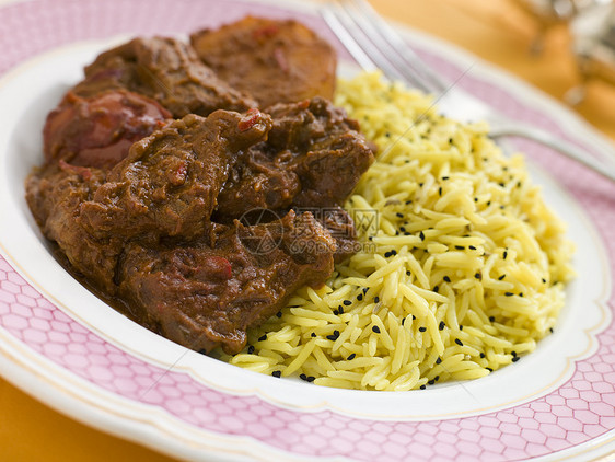 与皮劳赖斯的肉品达洛Vindaloo谷物盘子粮食食物羊肉食品黑种草辣椒肉桂米果图片