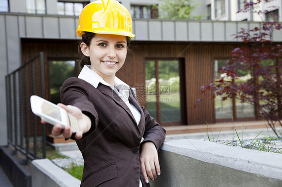 年轻女性有电话的建筑工程青年工人就业商业专家手机顾问建设者工作帽子呼唤图片