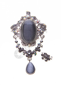 在背景上有着不同宝石的胸针金子古董项链叶子钻石水晶吊坠魅力石头礼物图片