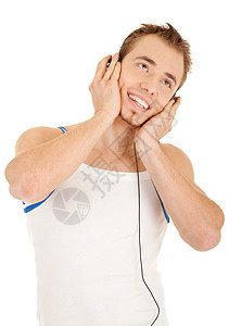 笑得帅帅的男人在听音乐音乐播放器技术耳机乐趣工作室娱乐享受喜悦衬衫微笑图片