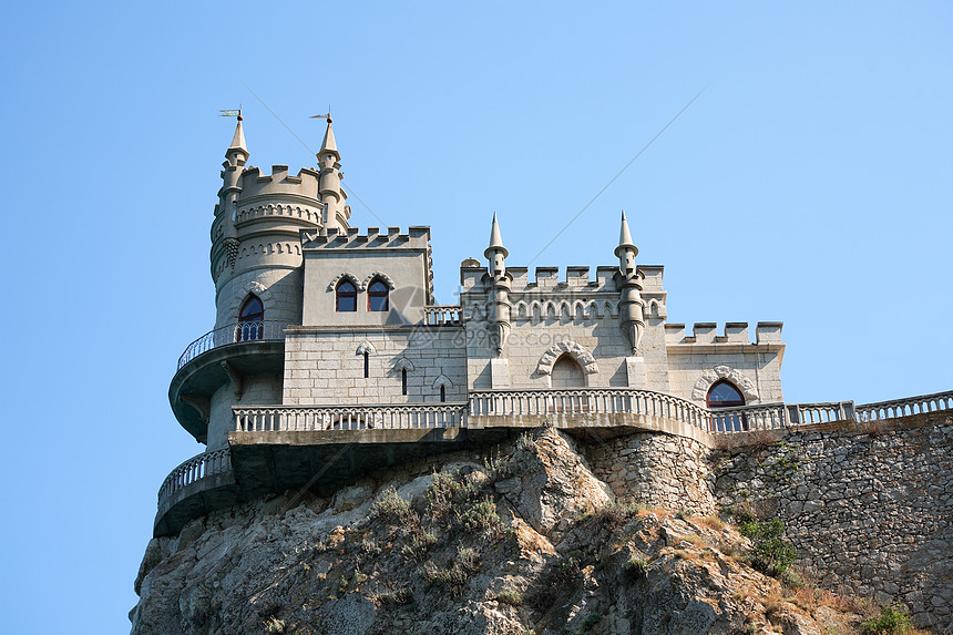 岩上城堡首脑据点悬崖波峰蓝色建筑学动物旅行房子石头图片