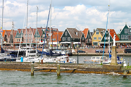 荷兰 Volendam港的船舶蓝色建筑船尾假期旅行城市阳光邮轮游客码头图片