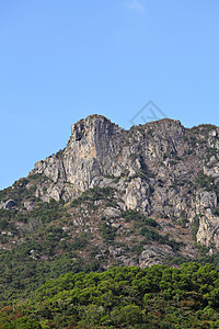 狮子摇滚 狮子像香港的山峰一样 是精神爬坡晴天天空白色城市地标岩石蓝色绿色图片