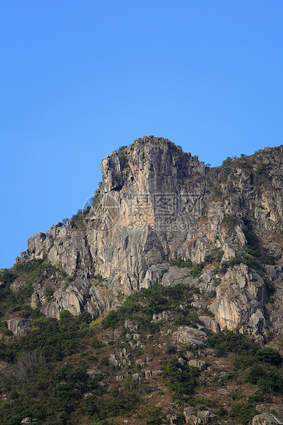 香港的狮子石晴天精神天空头脑市中心岩石城市爬坡绿色狮子图片
