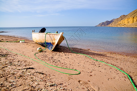 海滩上的船文化风景太阳漂浮热带阳光工艺蓝色钓鱼工具图片