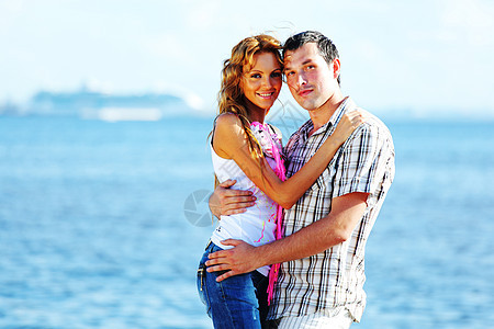 拥抱在海面上蓝色成人季节蜜月情人快乐牙齿自由友谊女性图片