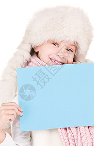 身戴冬帽 带空白板的女孩帽子广告孩子微笑快乐木板女性棉被推介会卡片图片