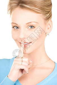 嘴唇上的手指警告商务手势金发女郎微笑女性阴谋女孩成人人士图片