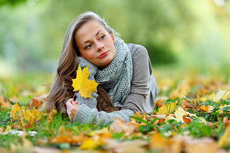 秋叶中的妇女脚尖眼睛橙子女性毛衣女孩季节女士公园幸福感恩图片
