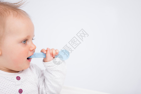 可爱的婴儿咬蓝勺子图片