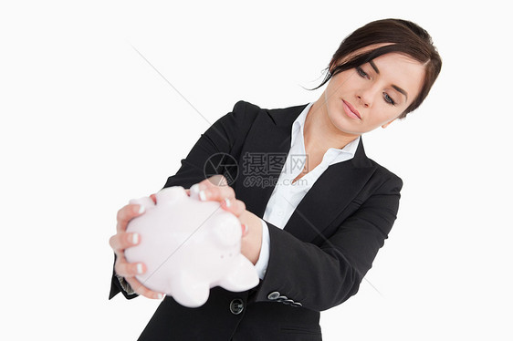年轻女青年在西装 空空小猪银行图片