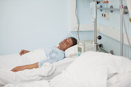 男病人躺在医疗床的病床上图片