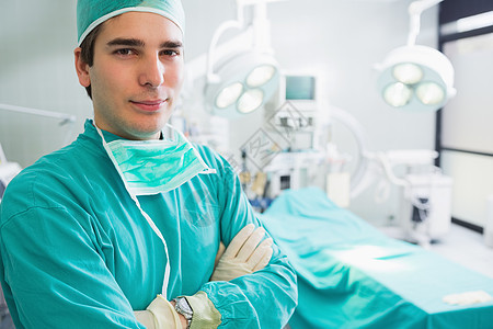 外科医生看镜头面具男性手术手术室制服男人双臂手术帽闪电卫生图片