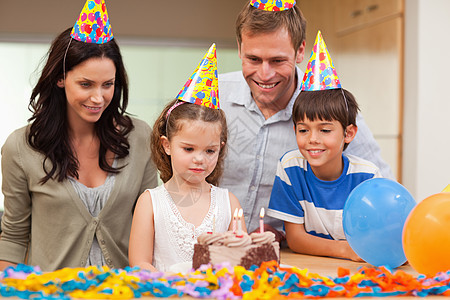 女孩即将吹熄蜡烛 在她的生日蛋糕上图片